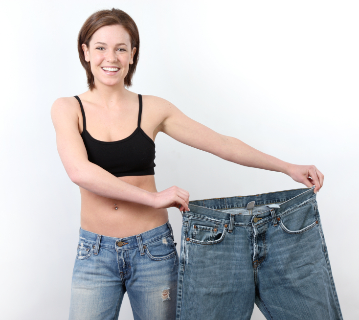 Woman showing her old big loose pants after massive weight loss